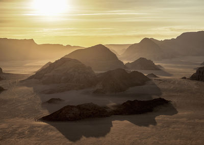 Scenic view of rocky mountains against sky during sunset