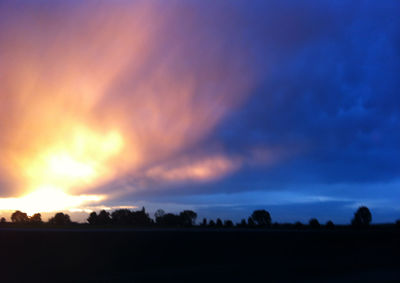 Silhouette landscape against sky during sunset