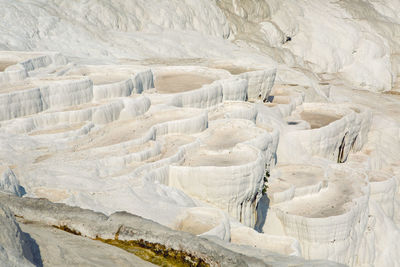 White calcium mountain with granite with small waterfall in summer in pamukkale turkey