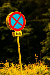 Close-up of road sign against blurred background