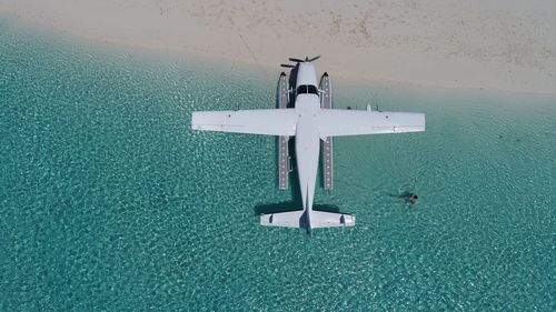 High angle view of sea against blue wall