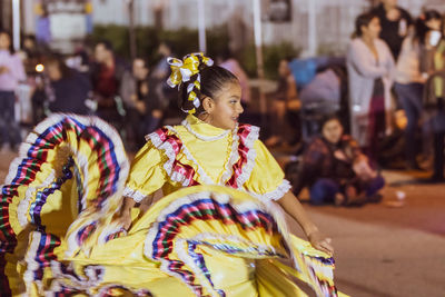 View of dancing girl in traditional clothing