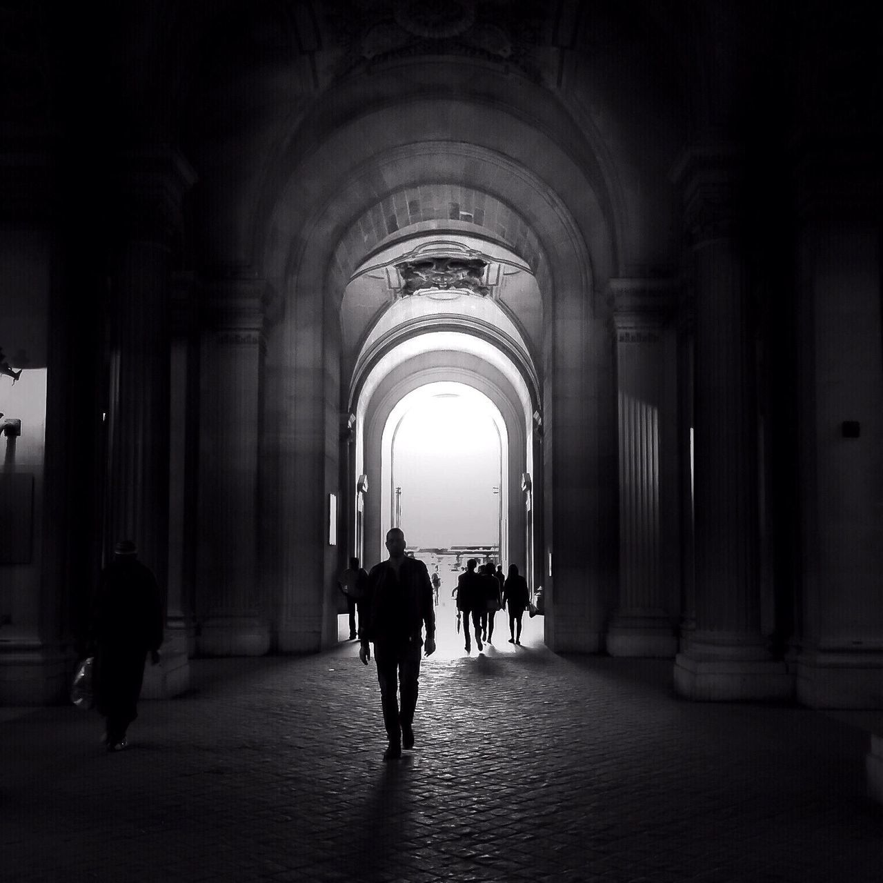 indoors, men, walking, full length, lifestyles, person, arch, rear view, silhouette, architecture, leisure activity, corridor, built structure, architectural column, togetherness, standing, the way forward