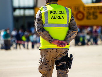 Midsection of man standing with text