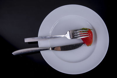 High angle view of plate and knife on table