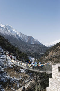 People on mountains against sky