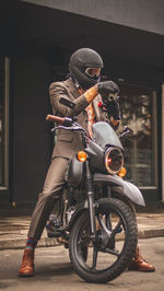 Man riding motor scooter on street