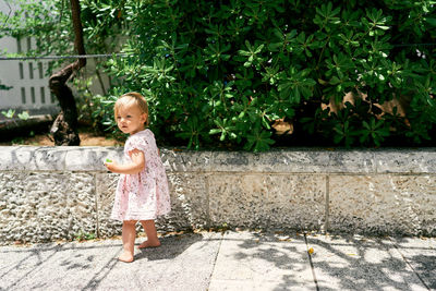 Full length of cute girl against plants