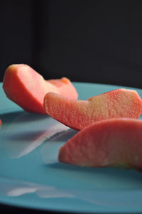 Close-up of apple slices over black background