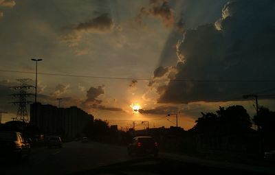 View of road against cloudy sky at sunset