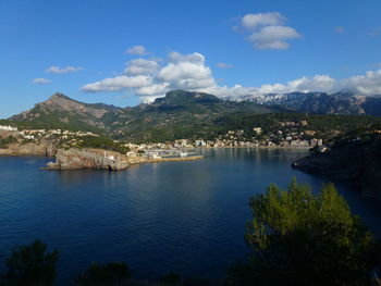 Scenic view of townscape by sea against sky porto soller, majorca