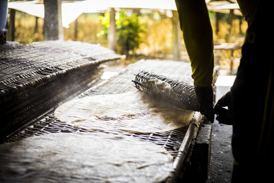 Close up on putting steamy baked rice paper on mats