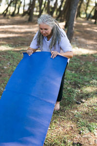 Portrait of young woman sitting on field