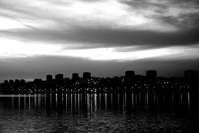 View of river against cloudy sky at sunset