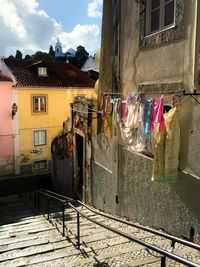 Clothes drying on street by buildings in city