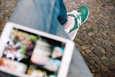 Low section of woman wearing canvas shoes