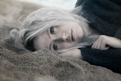 Close-up portrait of woman lying down