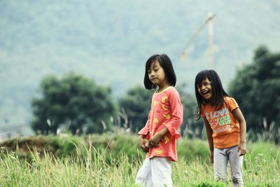 Siblings walking on land