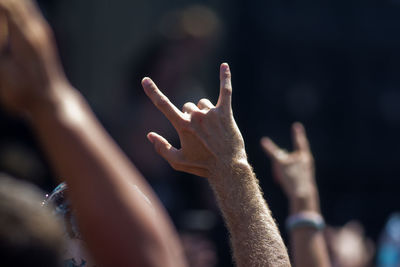 Close-up of hands of people in background