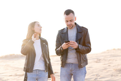 Couple wearing jacket standing outdoors