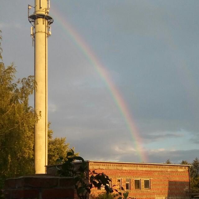 rainbow, multi colored, architecture, built structure, building exterior, low angle view, arch, colorful, beauty in nature, sky, day, nature, scenics, tranquility, no people, outdoors, town, majestic, cloud - sky, natural phenomenon, high section, tranquil scene