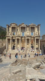 Tourists at celsus library against clear sky