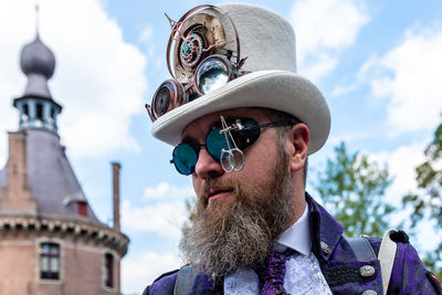 Portrait of man wearing hat against sky