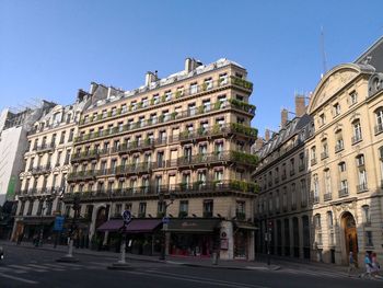 Buildings in city against clear sky