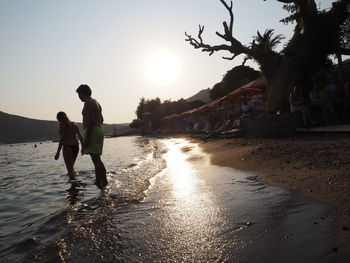 People on beach at sunset