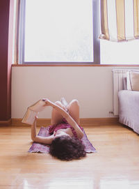 Woman lying on floor at home