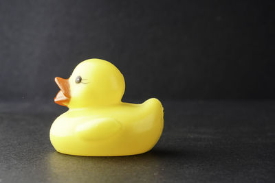 Close-up of yellow toy over black background