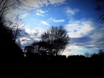 Silhouette trees on landscape against sky