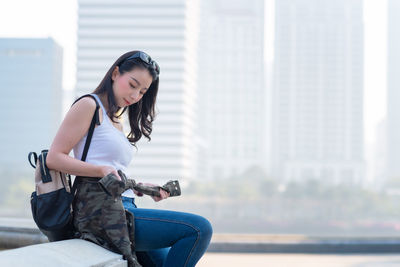 Young woman sitting outdoors