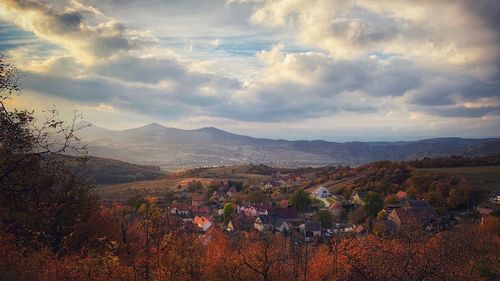 Scenic view of townscape against sky during autumn