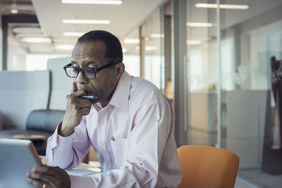 Businessman working alone in office using digital tablet