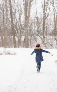 Full length of person on snow covered landscape