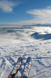 High angle view of shoes on snowcapped mountain against sky