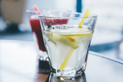 Close-up of lemonade with drink on table