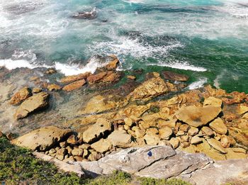 High angle view of rocks at sea shore