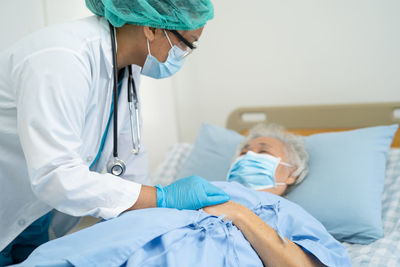 Female doctor examining patient at hospital