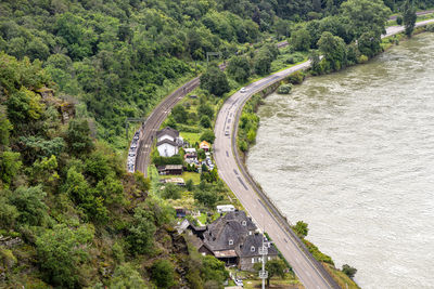 The river rhine in western germany flows between the hills covered with forest.