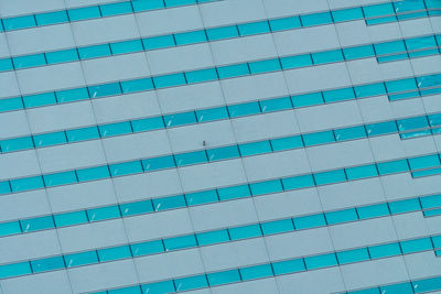 Full frame shot of modern blue building against sky