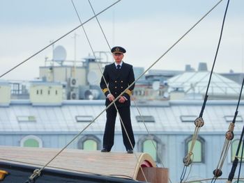 Full length of man standing in sea against sky