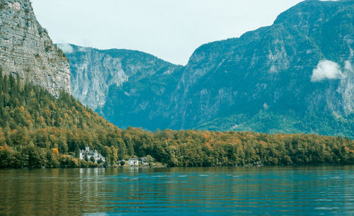 Scenic view of lake by mountains against sky