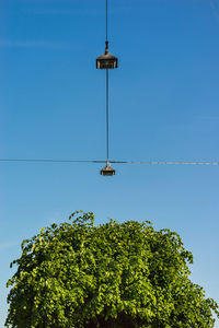 Low angle view of cable against clear blue sky