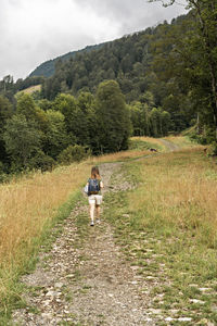 Rear view of women walking on mountain road