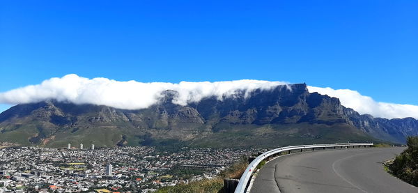 Scenic view of mountains against blue sky