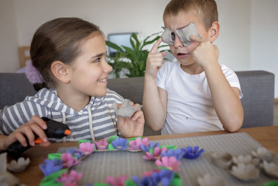 Kids create easter flower wreath in pastel colors using an upcycled egg trail. zero waste lifestyle