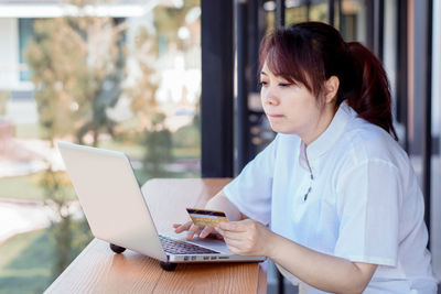 Mid adult woman using mobile phone