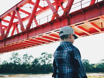 Man standing on bridge